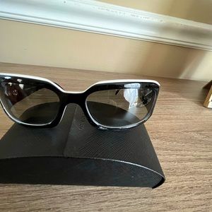 Chanel sunglasses. Black frame trimmed in white. Black lens. Very classy!